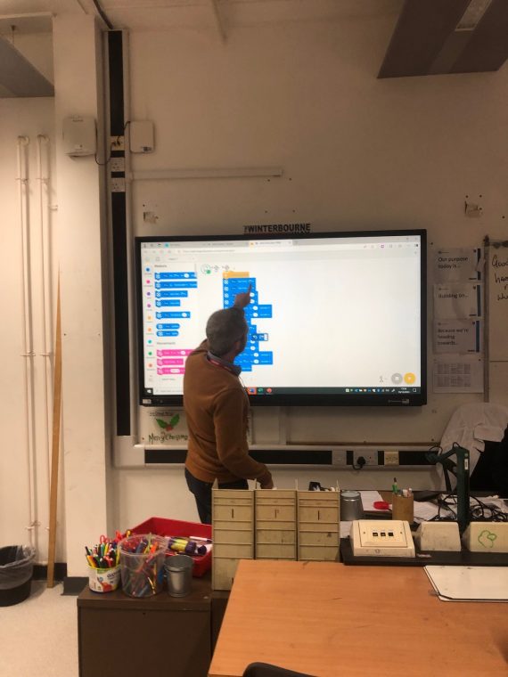 Sam supporting the kids with coding